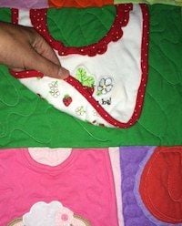 close up of a baby clothes quilt close up of a baby clothes quilt