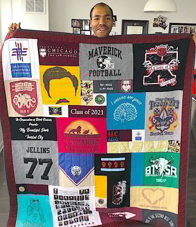 Man holding quilt with 2 border
